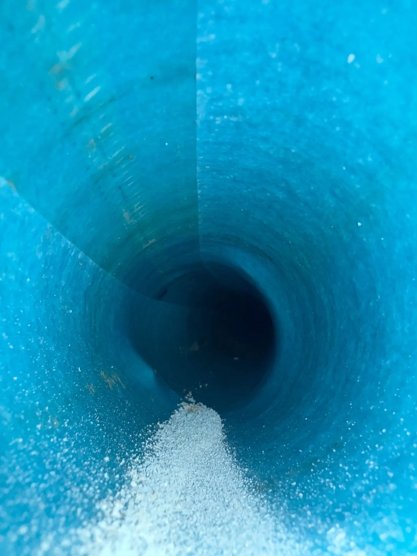 View straight down the barrel of a freshly cured blue sewer liner in a residential lateral