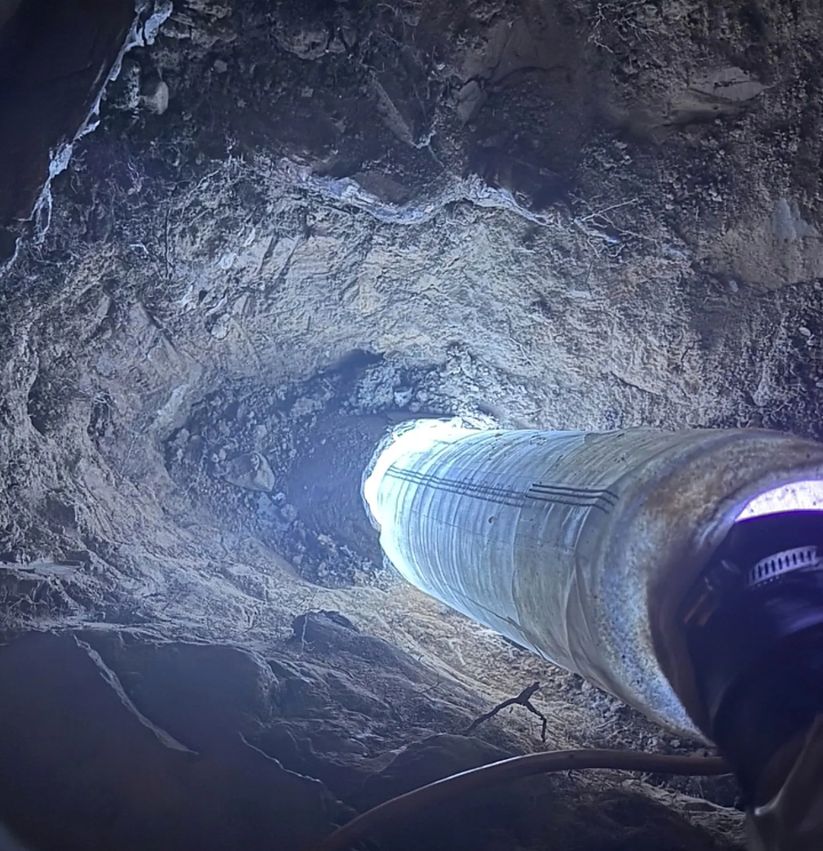 Open trench with a pipe liner curing under a blue UV light
